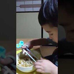 My son trying out chopsticks.