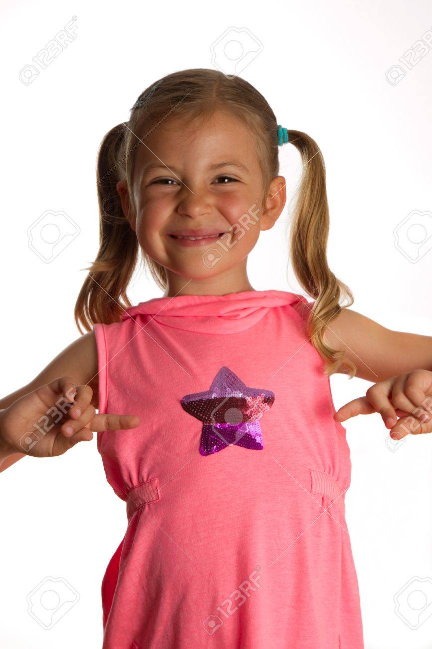 6990566-Little-girl-pointing-to-the-star-on-her-dress-and-grinning-Stock-Photo.jpg