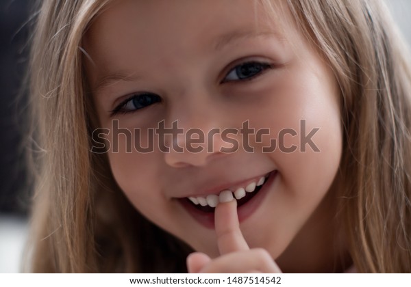 blueeyed-blond-girl-laughs-shows-600w-1487514542.jpg