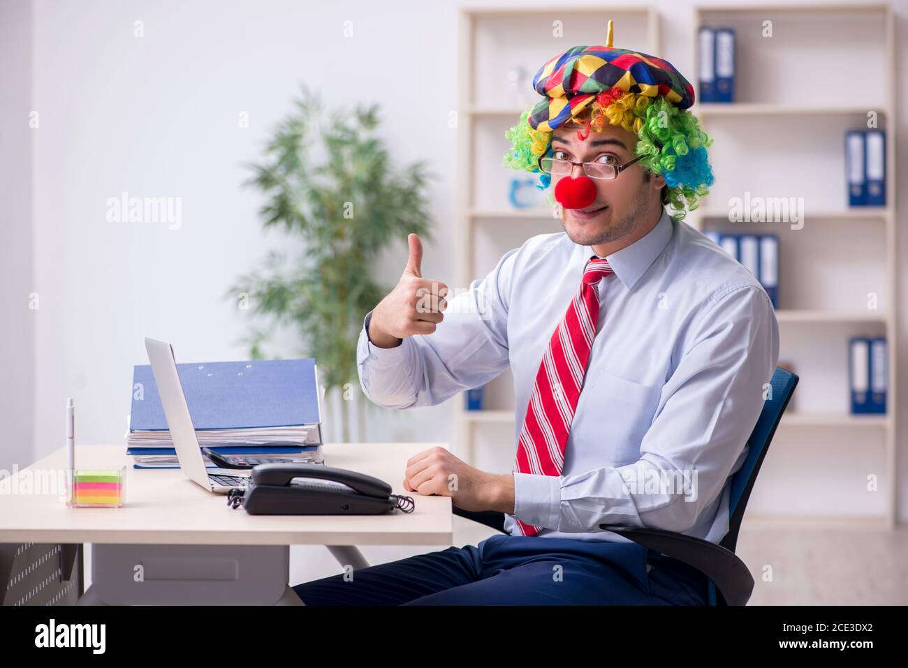 funny-employee-clown-working-in-the-office-room-2CE3DX2.jpg