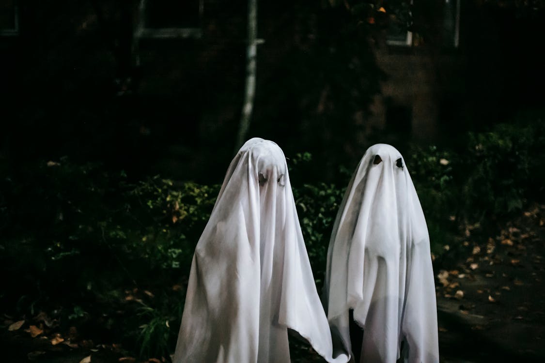 Unrecognizable children in ghost costumes in town · Free Stock Photo