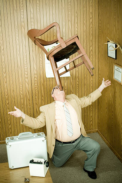 businessman-balancing-chair-in-mouth.jpg