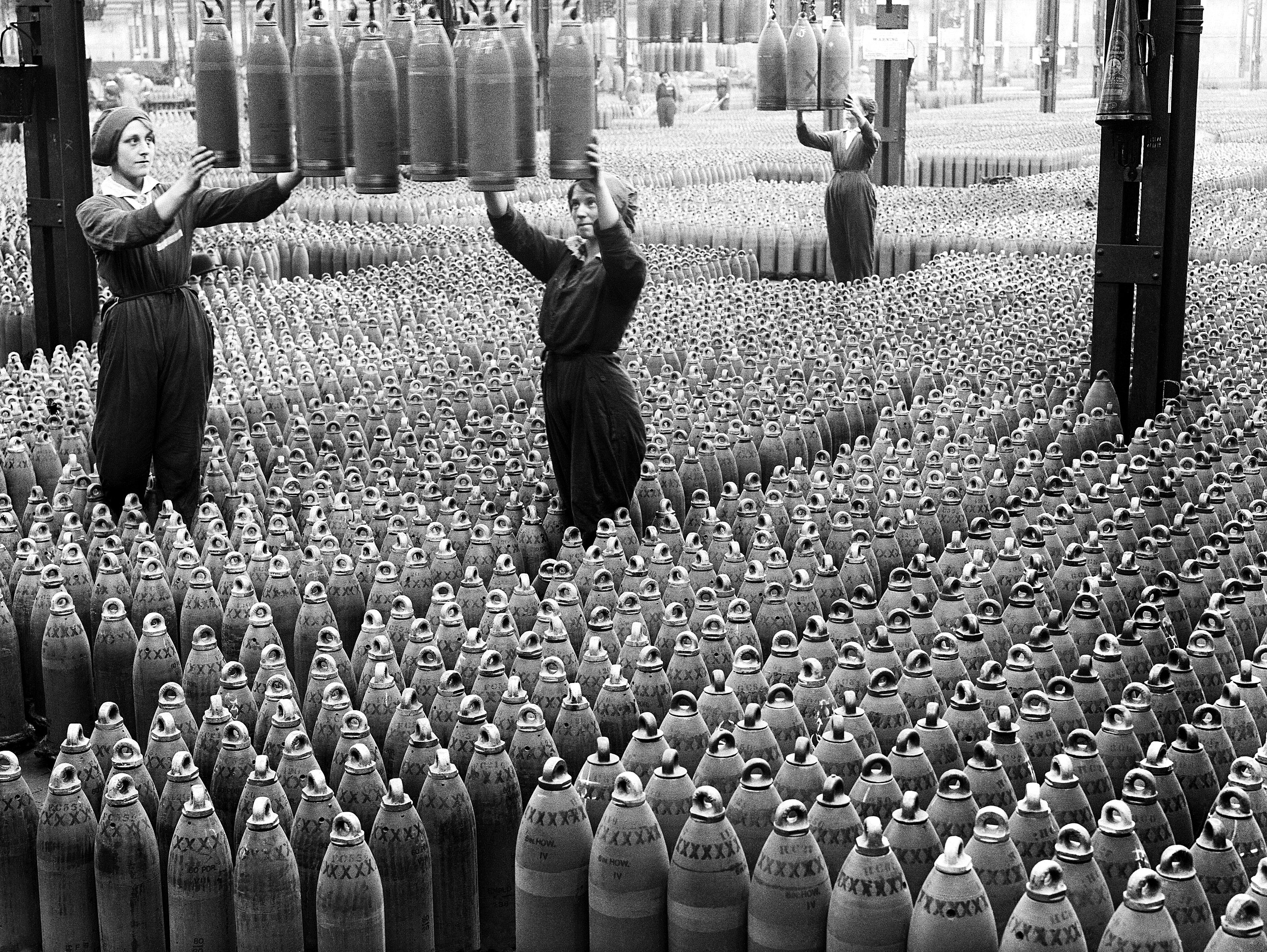 2560px-Women_workers_with_shells_in_Chilwell_filling_factory_1917_IWM_Q_30040.jpg